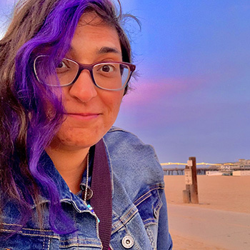 White man with ombre colored spectacles and a blue button-down shirt